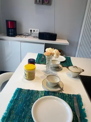 a table with three bowls and a vase on it at Chambre d hote in Olne