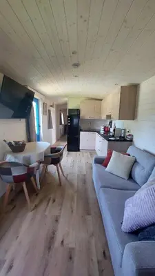 a living room with a couch and a table and a kitchen at Puck B&B Babbita in Hasselt