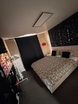 a bedroom with a bed in a room at La Suite Gold Wellness Jacuzzi & Sauna in Seraing