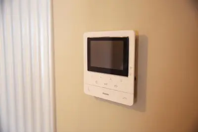 a computer monitor on a wall next to a window at Le 118 Guillemins, avec Parking in Liège