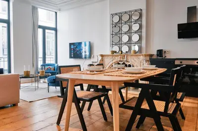 a dining room with a table and chairs at Urbanchic Appartement élégance hyper centre in Liège