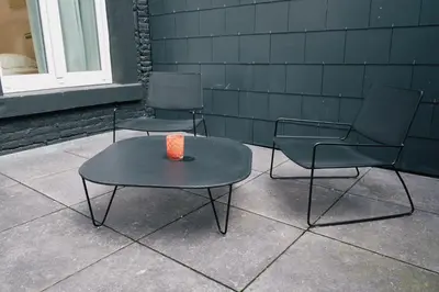 two chairs and a table with a candle on it at Urbanchic Appartement élégance hyper centre in Liège