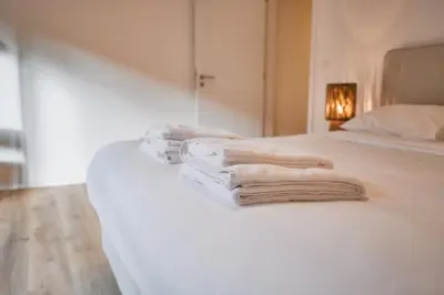 a group of towels sitting on the edge of a bed at Urbanchic Appartement cosy 1B in Liège