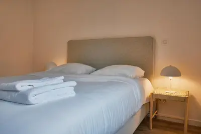 a bedroom with a bed with white towels on it at Urbanchic Appartement Chill 3B in Liège