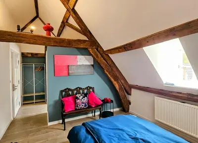 a bedroom with a blue bed with pink pillows at Das GANZE Chateau Thor - bis zu 22 Personen in Lontzen
