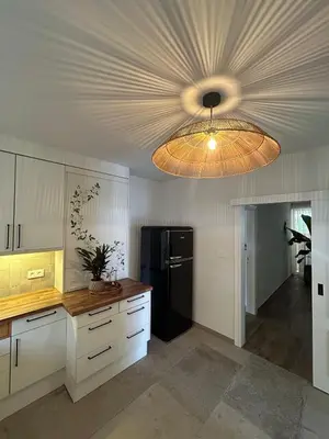 a kitchen with a black refrigerator and a ceiling at Puur17 in Lommel