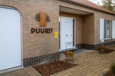 a brick building with a purvy sign on it at Puur17 in Lommel