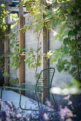 a green bench sitting in front of a building at ViaAmbioriX in Tongeren