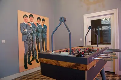 a painting of soldiers on the wall in a room at A la Maison in Heks