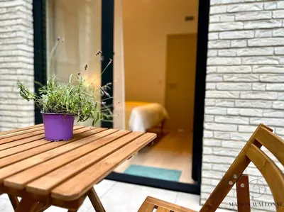 a potted plant sitting on top of a wooden table at Le paisible écrin - Hypercentre avec Parking in Liège