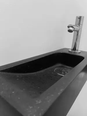 a black sink with a faucet on top of it at Vakantiewoning Huis 8 in Tongeren
