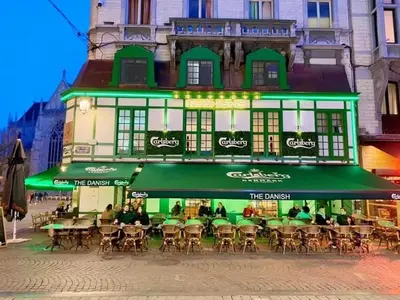 a restaurant with tables and chairs in front of a building at Charming Apartment in Liège City Centre with Parking Included in Liège