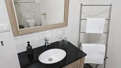 a bathroom with a sink and a mirror at Vakantiehuis Pippa in Peer