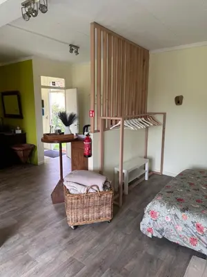 a bedroom with a bed and a desk and a bunk bed at B&B Bombon in Herk-de-Stad