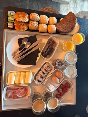 a tray filled with different types of food on a table at B&B Bombon in Herk-de-Stad