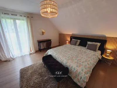a bedroom with a bed and a couch in it at Villa VIP in Welkenraedt