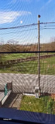 a view of a road with a fence and a pole at Entre deux Ô à Lixhe,Visé Belgique in Visé