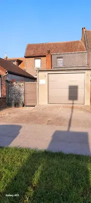 a shadow of a street sign in front of a garage at Entre deux Ô à Lixhe,Visé Belgique in Visé