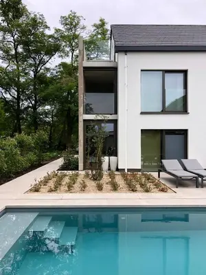 a house with a swimming pool in front of it at Huis Vanellus in Hasselt
