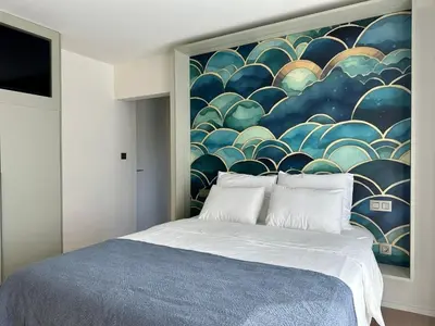 a bedroom with a large painting on the wall at Huis Vanellus in Hasselt