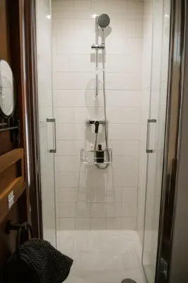 a shower with a glass door in a bathroom at La Nano Maison de Liège in Liège