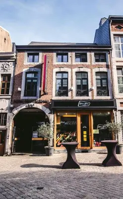 a building with two vases in front of it at La Nano Maison de Liège in Liège