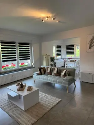 a living room with a couch and a table at Comme chez vous in Soumagne