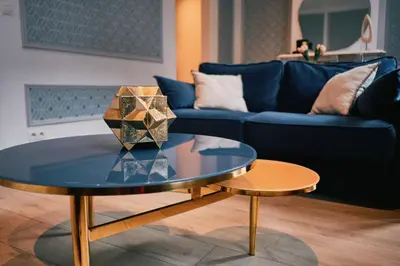 a living room with a blue couch and a table at Urbanchic Adalbert 1A in Liège