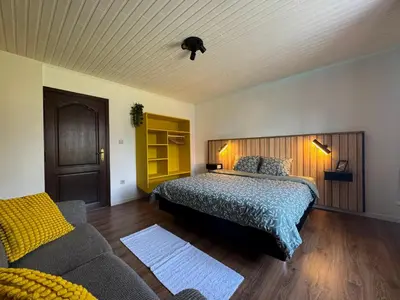 a bedroom with a bed and a couch at Casa Fratello Bolderberg in Heusden - Zolder