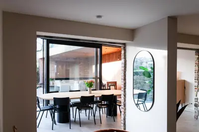 a dining room with a table and chairs at Vakantiehuis Remersdaal in Voeren