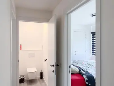 a bedroom with a bed and a door to a bathroom at Lindehoeve in Heusden - Zolder