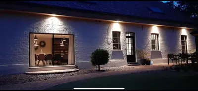 a white brick house with a window at night at Vakantiehuis Bonne Home in Bree