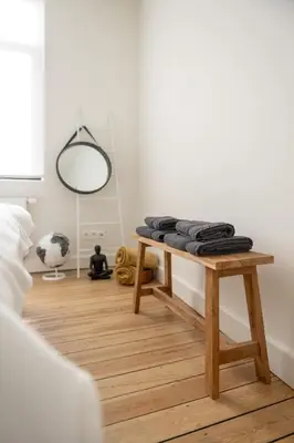 a room with a wooden table with a mirror at Chill Hill in Hasselt