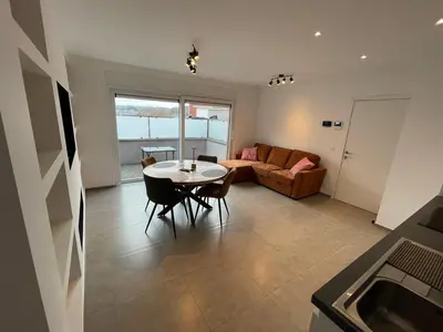 a living room with a table and a couch at Residence pascalino in Ans
