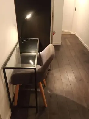 a chair sitting next to a glass table at La Vie Hors Château in Liège