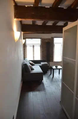 a living room with a couch and a table at La Vie Hors Château in Liège
