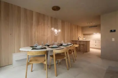 a dining room with a white table and chairs at Lodge met Jacuzzi - 8 personen - Woodz Lodges in Heusden - Zolder