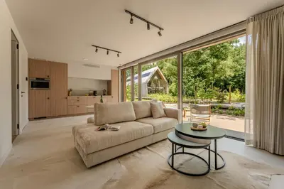 a living room with a couch and a table at Suite Toegankelijk | 2 personen in Heusden - Zolder