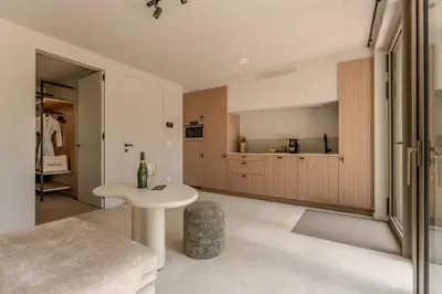 a living room with a table and a kitchen at Groepslodge - 10 personen - Woodz Lodges in Heusden - Zolder