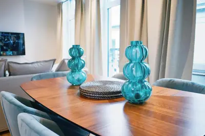 two blue vases sitting on top of a wooden table at Urbanchic Duplex Adalbert 2A in Liège