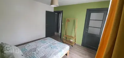 a bedroom with a bed and a room with a door at Au 167 Maison de Village in Seraing