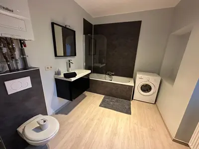 a bathroom with a sink and a washing machine at Au 167 Maison de Village in Seraing