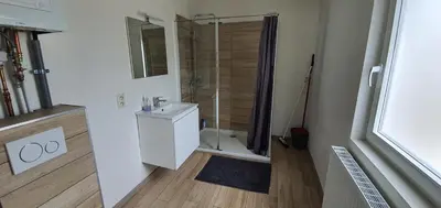 a bathroom with a shower and a toilet and a sink at Au 169 La maison du coin in Flémalle-Grande