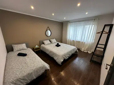 a bedroom with two beds and a ladder and a window at Au 11811 Bel appartement cosy in Loncin