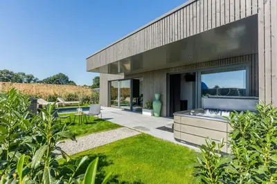 a modern house with a patio and a garden at le Bellessa Gite de luxe pour 2 personnes in Basse Tribomont