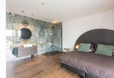 a bedroom with a bed and a vanity and a mirror at le Bellessa Gite de luxe pour 2 personnes in Basse Tribomont