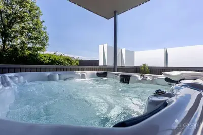 a jacuzzi hot tub in a backyard at Lodge 4 you gite de luxe pour 4 personnes in Verviers