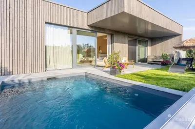 a swimming pool in front of a house at Gite SIWA pour 2 personnes in Verviers