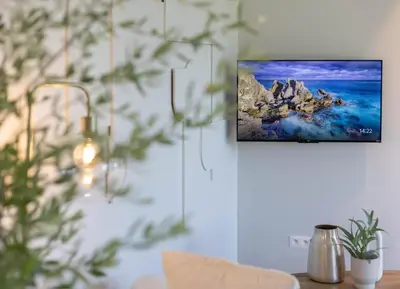 a living room with a picture hanging on a wall at Gite Olea de deux personnes in Basse Tribomont