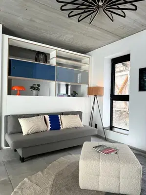 a living room with a couch and a table at lOFT 202 in Liège